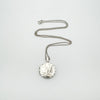Full view of vintage silver locket laid flat with 18 inch chain extended