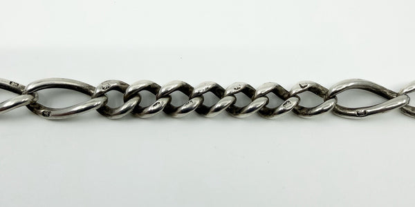 Close up of fancy Figaro links on antique sterling silver Albert chain with lion passant stamps