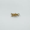 Pendant laid flat to show Sagittarius form with bow and hoop