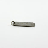 Vintage sterling silver ingot pendant lying flat with full hallmarks visible on the reverse.