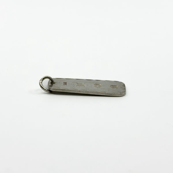 Vintage sterling silver ingot pendant lying flat with full hallmarks visible on the reverse.
