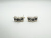 Pair of sterling silver black and white CZ earrings lying flat