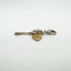 Flat profile of silver key and gold-plated heart charm pendant