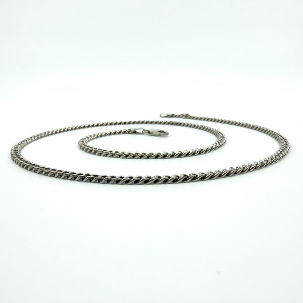 Angled view of the sterling silver flat link curb chain, showing the low-profile links.
