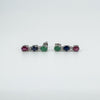 Sterling silver drop earrings laid flat showing ruby, sapphire, and emerald stones