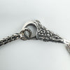 Close-up of floral engraved lobster clasp on Trollbeads bracelet