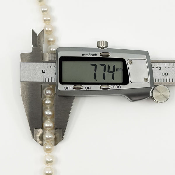 Freshwater pearl on new necklace measured at approximately 7.7mm with digital callipers