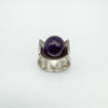 Straight front image of vintage amethyst ring with wide silver band and deep purple stone