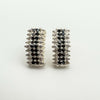 Chunky half hoop earrings in sterling silver set with black and white CZs
