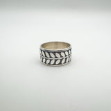 Wide sterling silver ring with engraved leaf design, front view