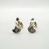 Pair of sterling silver earrings with natural diamonds in sculptural swirl shape