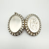 Both front and back views of large vintage sterling silver locket