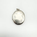 Chunky sterling silver oval locket with foliate engraving, blank central panel