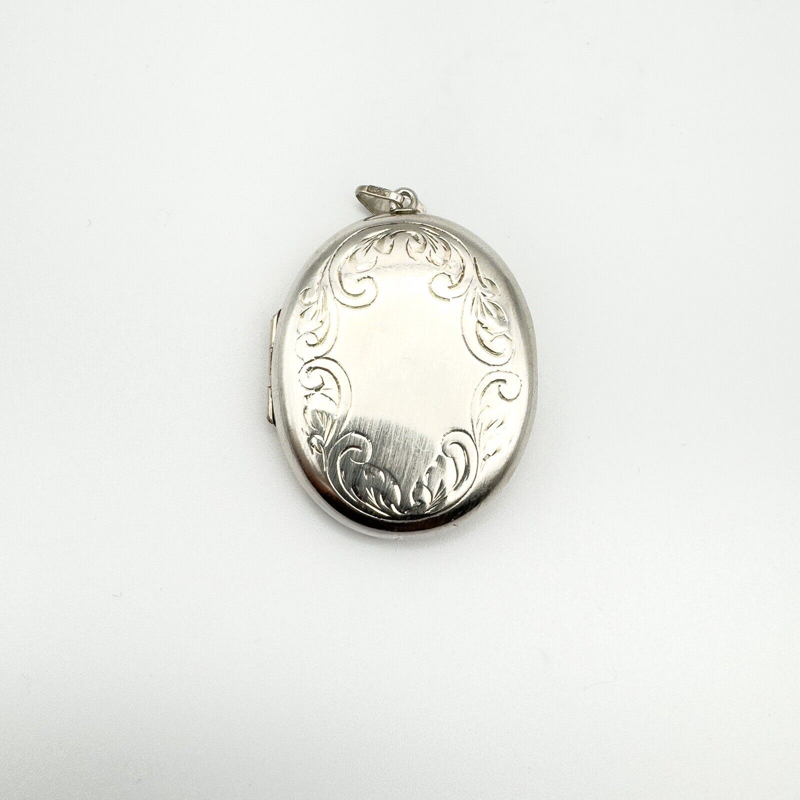 Chunky sterling silver oval locket with foliate engraving, blank central panel