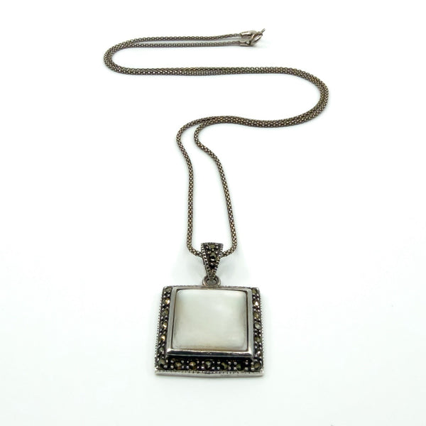 Sterling silver chain with mother of pearl and marcasite pendant laid flat, showing overall drop and proportions.