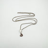 Full view of sterling silver chain with diamond pendant laid out