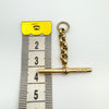Vintage 9ct gold T-bar pendant showing full length including belcher links beside tape measure