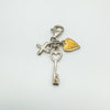 Full view of sterling silver diamond cross key and gold heart charm