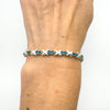 Full wrist view of secondhand blue CZ tennis bracelet in silver