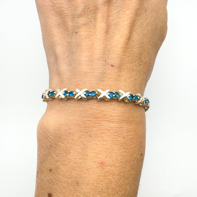 Full wrist view of secondhand blue CZ tennis bracelet in silver