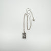 Vintage silver rectangular locket necklace with 18-inch chain laid flat