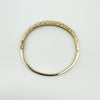 Top view of vintage 9ct gold bangle showing full oval shape and scroll pattern