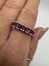 Pink rhodolite garnet ring in sterling silver shown worn on hand for scale and fit