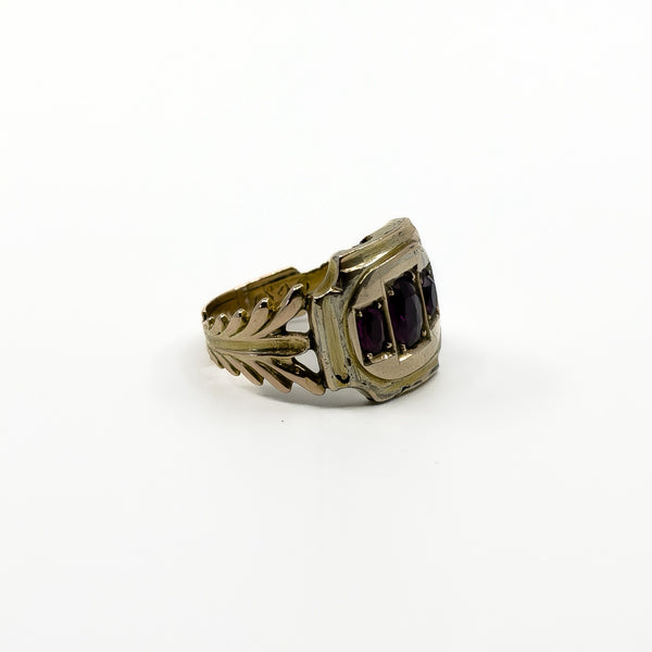 Side detail of antique Georgian 9ct gold amethyst trilogy ring with openwork shank and age-related wear