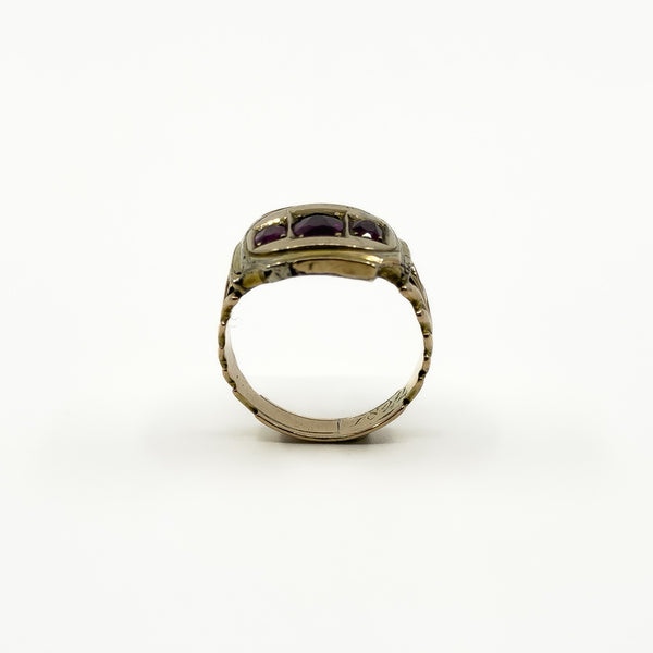 Side profile of antique 9ct gold amethyst trilogy ring with raised Georgian setting and visible band wear