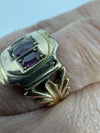 Worn side view of antique Georgian amethyst ring showing raised gold setting and fleur de lis shank