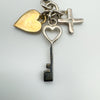 Detail view of gold-plated heart and heart-shaped silver key