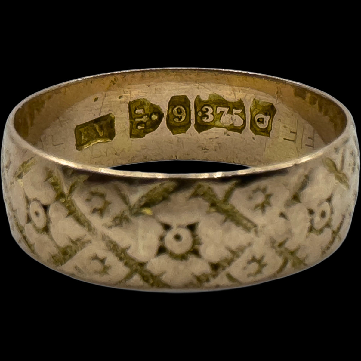 Close-up of gold ring hallmarks examined for antique and vintage jewellery listings
