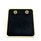 Vintage 9ct gold knot stud earrings displayed on black jewellery stand