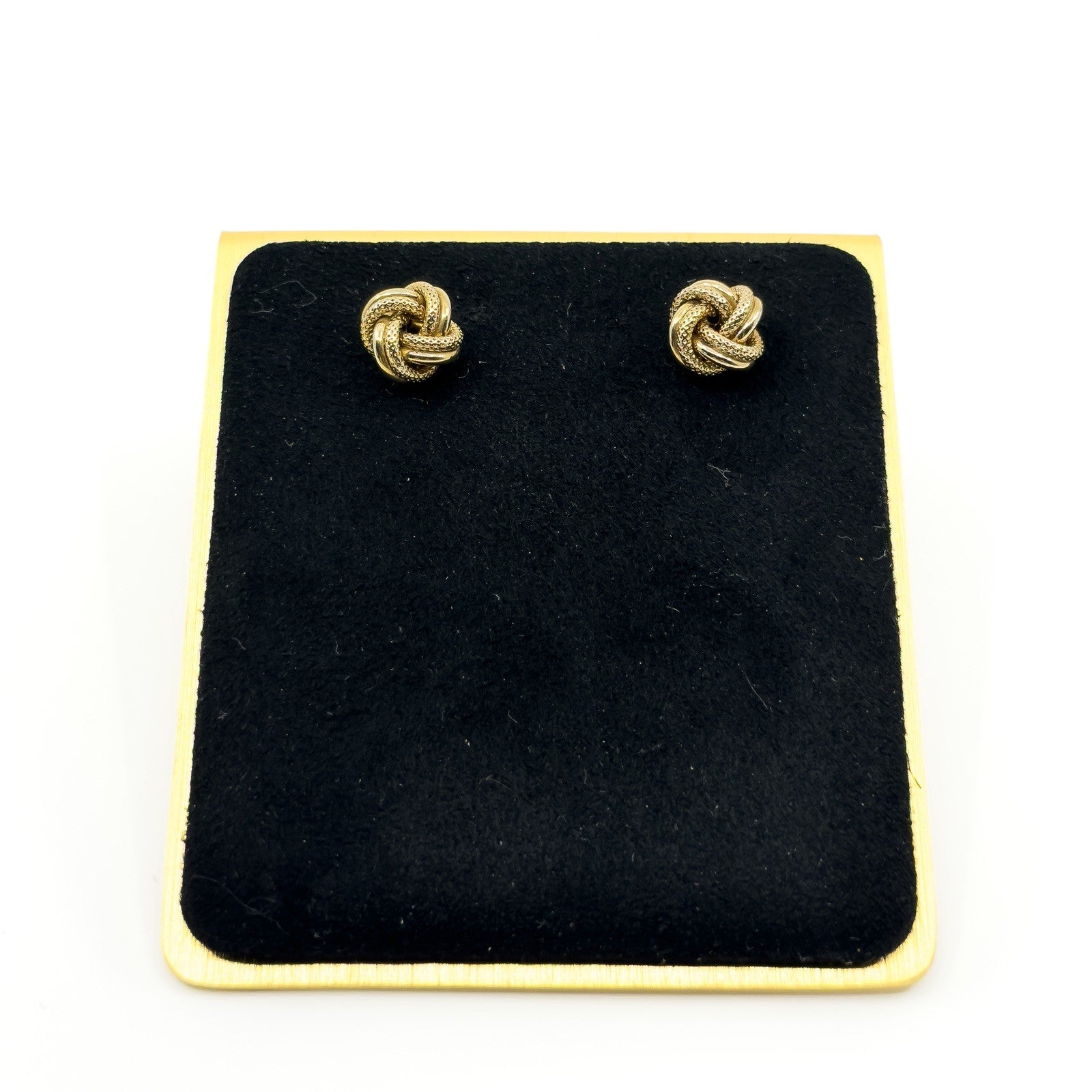 Vintage 9ct gold knot stud earrings displayed on black jewellery stand