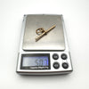 Antique 9ct rose gold T-bar pendant on scale weighing 5.07g