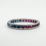 White gold eternity band with half sapphire and half ruby gems shown flat