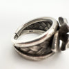Internal hallmark stamped 925 on open-back sterling silver floral ring