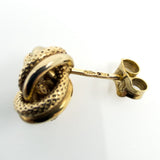 Close-up of 375 hallmark on vintage 9ct gold knot stud earring