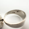 Close-up of Dublin 1975 hallmarks and M.M maker's mark inside silver ring band