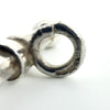 Macro photo of the hallmarks stamped on the bail ring of the sterling silver T-bar pendant.