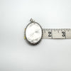 Measuring the length of the sterling silver locket with tape at 54mm