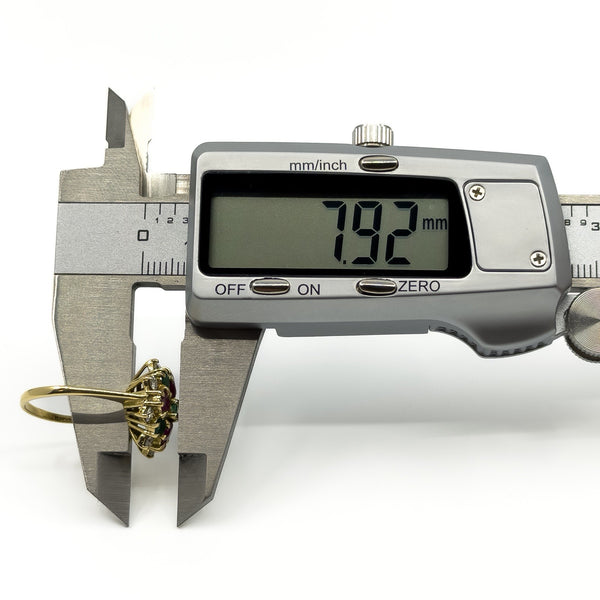 Caliper depth measurement of vintage 18ct gold gemstone cluster ring showing 7.92mm high setting
