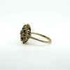 Opposite side view of vintage 18ct gold cluster ring showing the raised gemstone setting