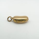 Close-up of side hinge and clasp on solid 18ct gold kidney bean locket pendant