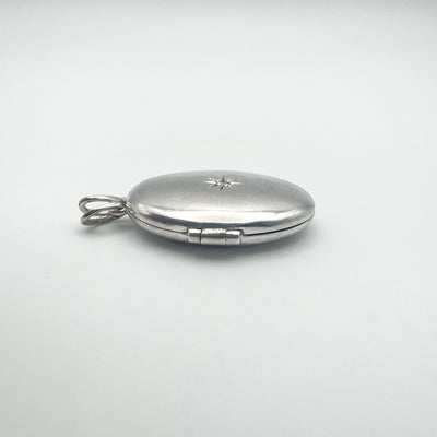 Side angle showing locket hinge and starburst top