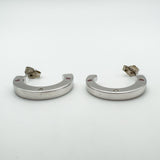 Earrings displayed horizontally to highlight depth and flat outer edge with gemstone accents