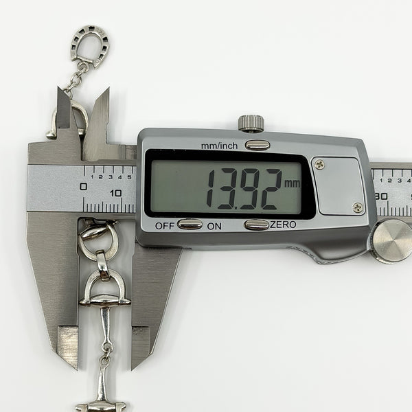 Digital caliper measuring the sterling silver horsebit bracelet link at approximately 13.92mm.