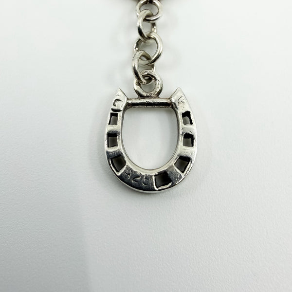 Close up of vintage sterling silver horsebit bracelet showing the 925 stamp on the horseshoe link.