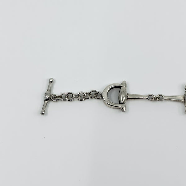 Close up of the sterling silver horseshoe end link on the vintage horsebit snaffle bracelet.