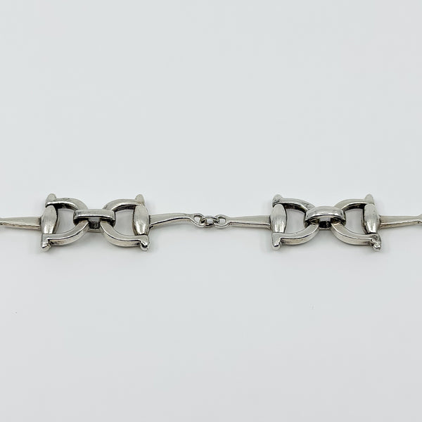 Vintage sterling silver horsebit snaffle bracelet showing two equestrian links and centre connector.